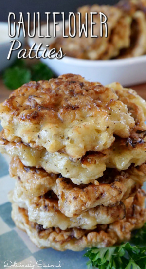 A stack of 5 cauliflower patties on a white and blue checkered square plate.