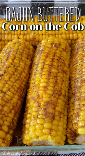 4 Cajun Buttered Corn on the Cob in a glass baking dish.