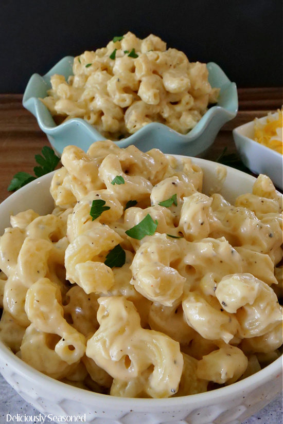 A white bowl filled with macaroni and cheese.