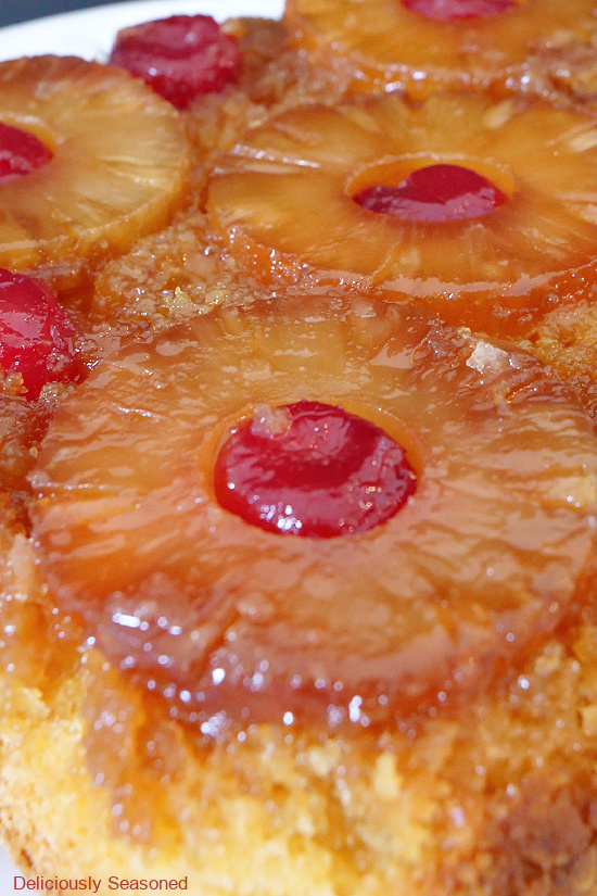 A very close up photo of a pineapple upside down cake.