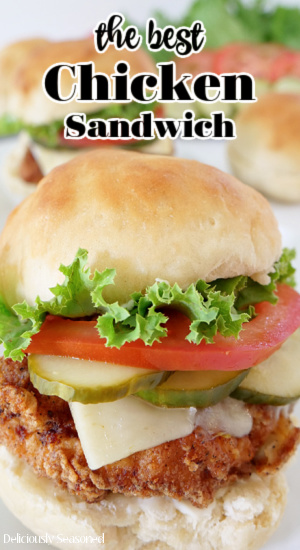 A close up picture of The Best Chicken Sandwich with Chicken Sandwiches and vegetables in the background. The title in centered at the top of the picture.
