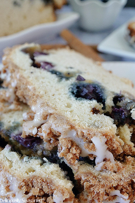 A close up photo of two slices of Blueberry Streusel Cake on a white plate.