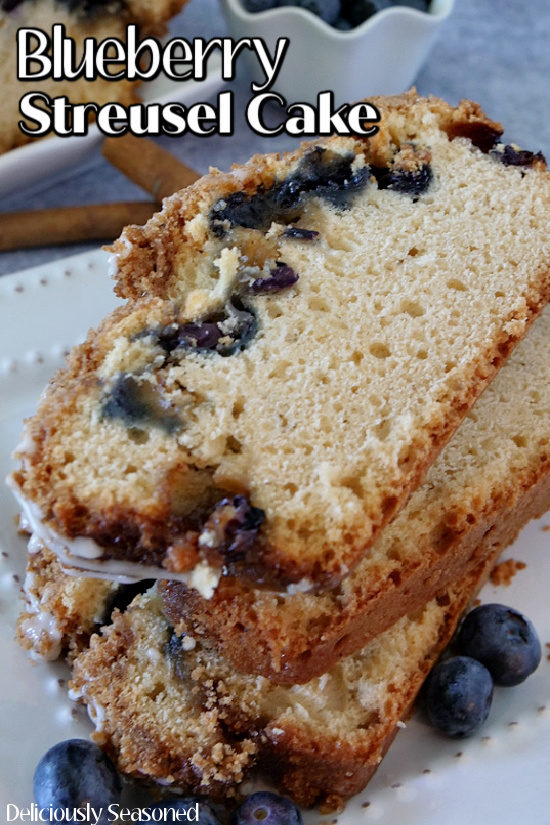 Three slices of Blueberry Streusel Cake stacked on top of each other all placed on a white plate.