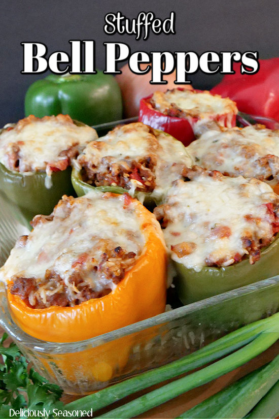 A glass 8 by 8 baking dish filled with stuffed bell peppers.