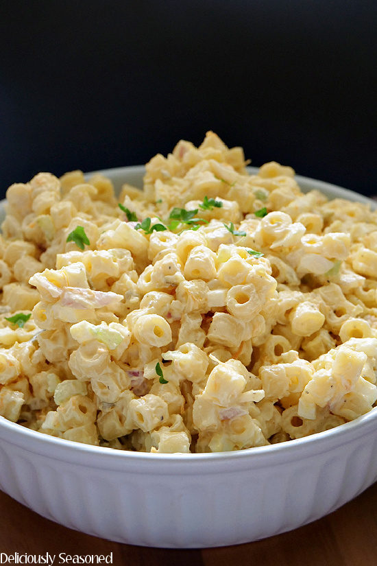 A light colored bowl filled with homemade macaroni salad.