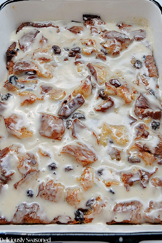 Cinnamon Raisin Bread Pudding in a large casserole dish topped with a sweet glaze.
