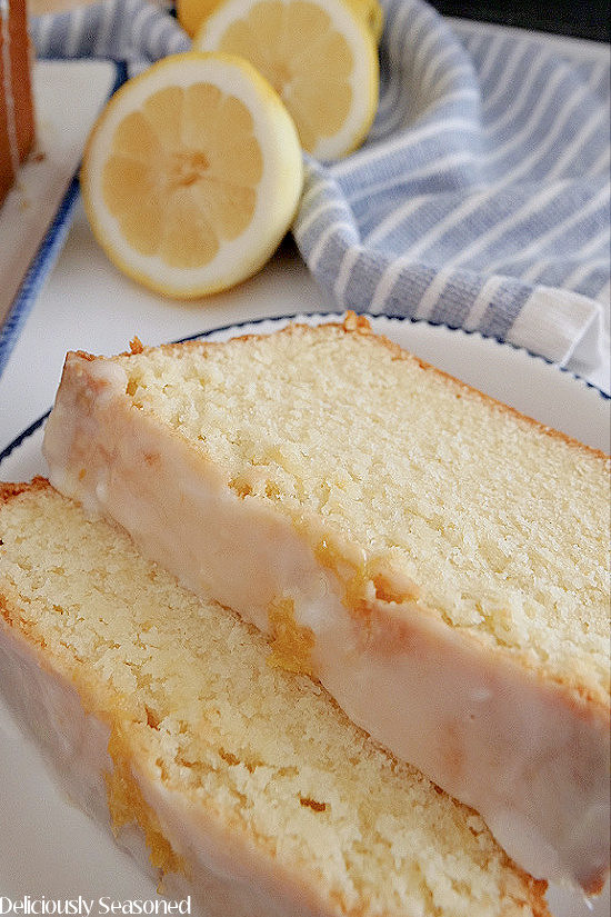 A close up photo of two slices of lemon pound cake on a white plate.