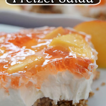 A slice of peach pretzel salad on a white plate with a bite taken out of it.