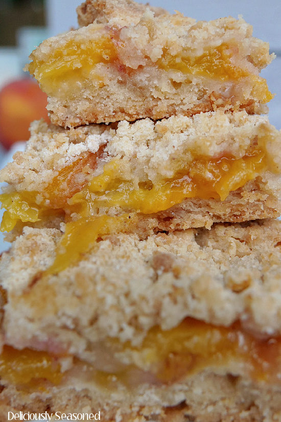 A super close up of 3 peach crumb bars.