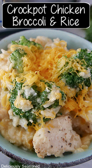A close up photo of a blue bowl with a serving of crockpot chicken broccoli rice in it, and the title of the recipe at the top of the photo. 