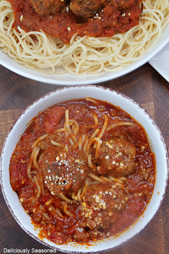 An overhead photo of spaghetti and meatballs in a large white bowl.