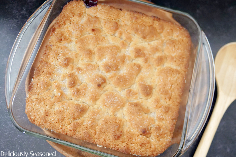An 8 by 8 square baking dish of blackberry cobbler.