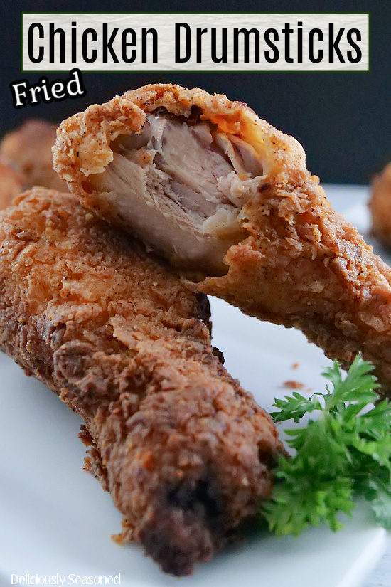 Two chicken drumsticks on a white plate with the title of the recipe at the top of the photo.
