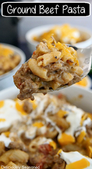 A close up photo of a spoonful of ground beef pasta with the title of the recipe at the top of the photo.