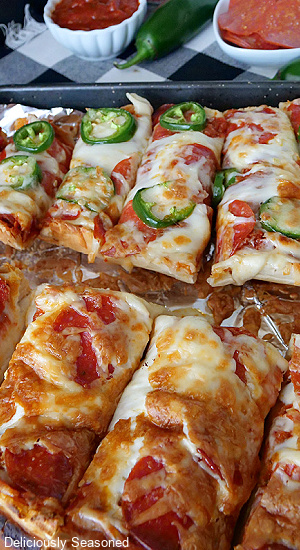 A baking sheet with slices of French Bread pizza on it.