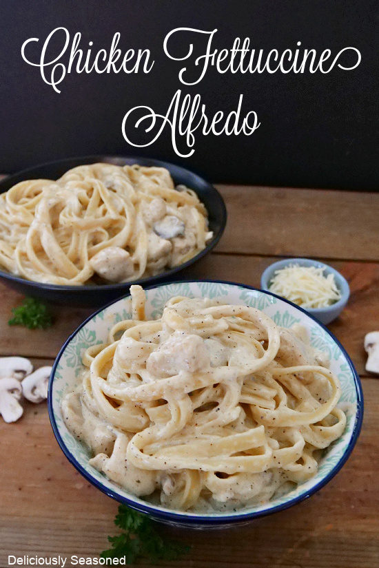 Two bowls filled with chicken fettuccine alfredo pasta.