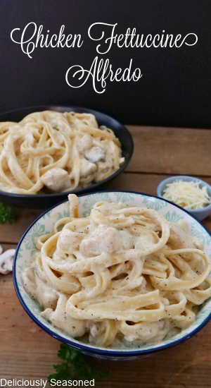 Two bowls filled with chicken alfredo pasta with fettuccine noodles.