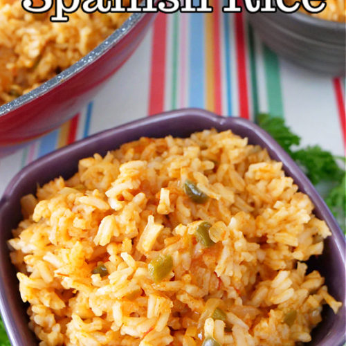 A purple square shaped bowl filled with Spanish rice, sitting on a colorful striped placemat.