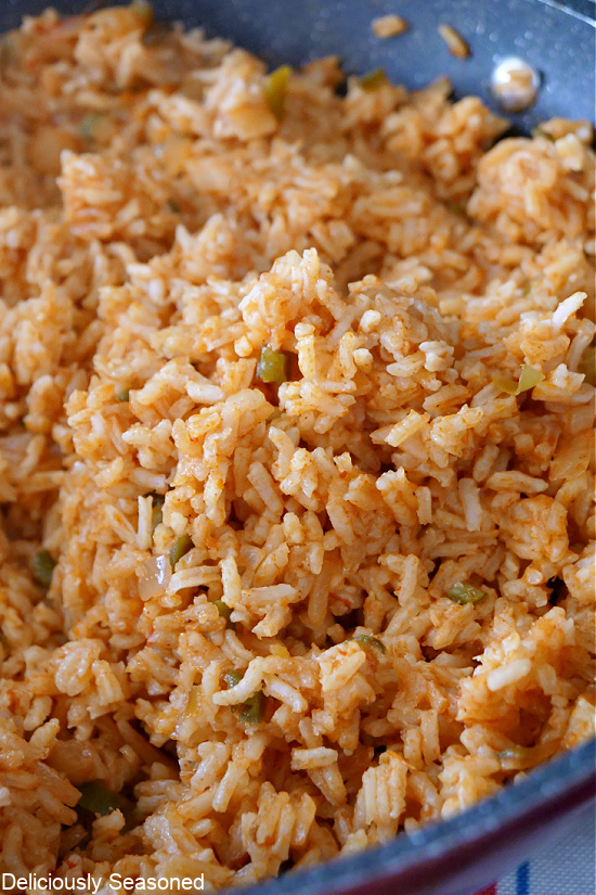 A close up photo of Spanish rice in a pan.
