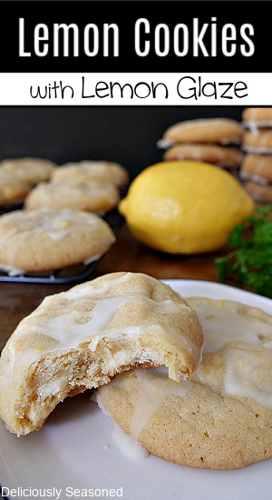 Two lemon cookies on a white plate with more cookies in the background with the title of the recipe at the top of the photo.