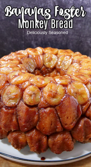 Monkey bread topped with a sauce and sliced bananas.