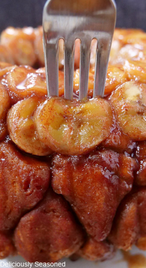 A fork sticking in a piece of monkey bread.