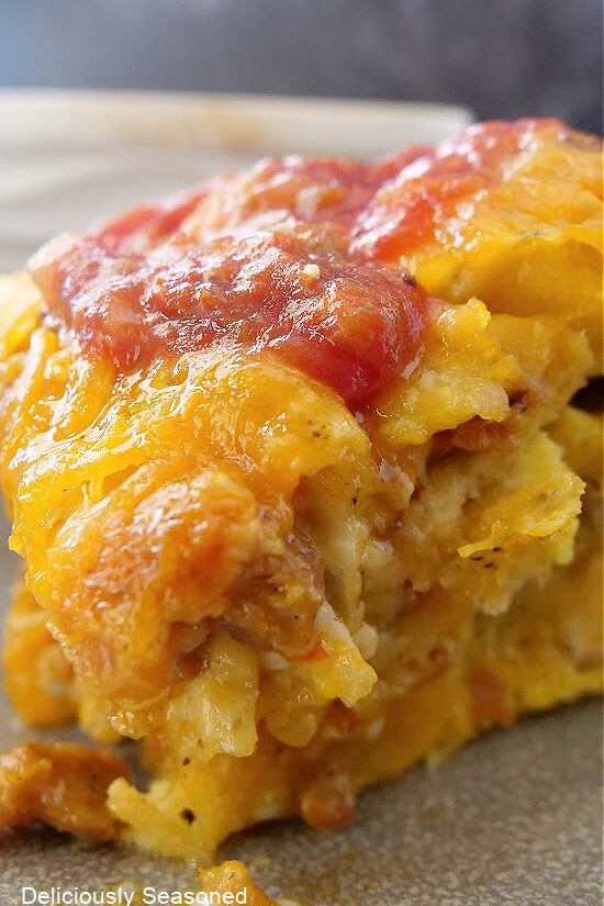 A close up photo of a serving of biscuit breakfast casserole.