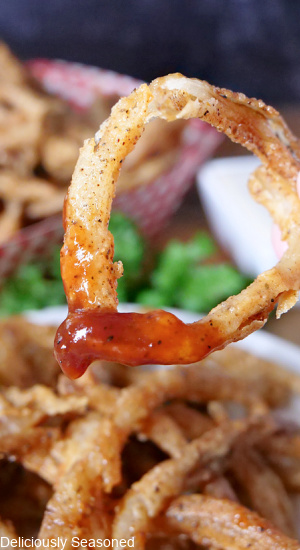 An onion string dipped in barbecue sauce.