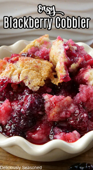 A close-up picture of blackberry cobbler in a white bowl with the title at the top.