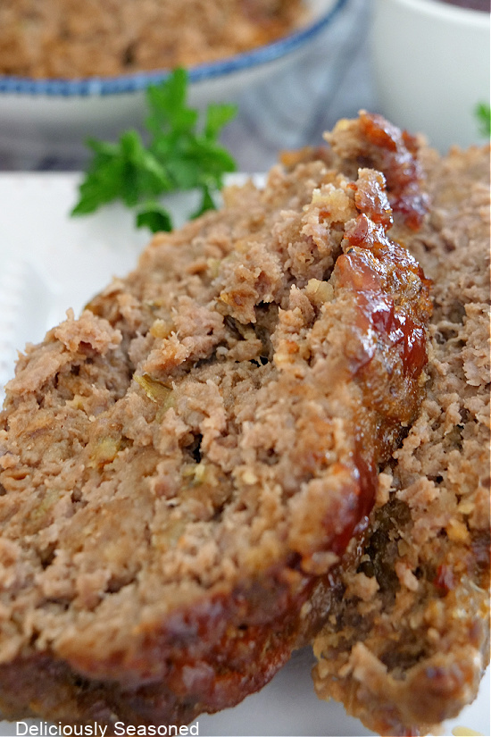 A close up photo of two slices of meatloaf.