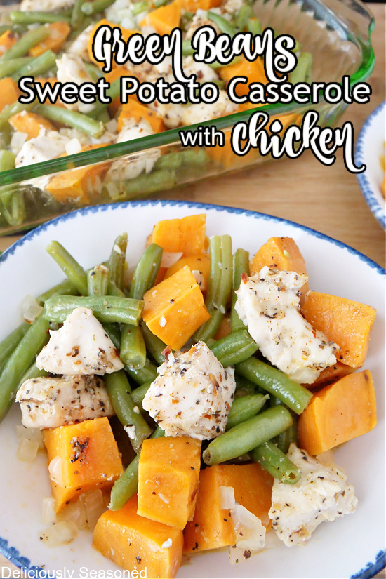 Chicken, green beans and sweet potatoes in a white bowl with blue trim.