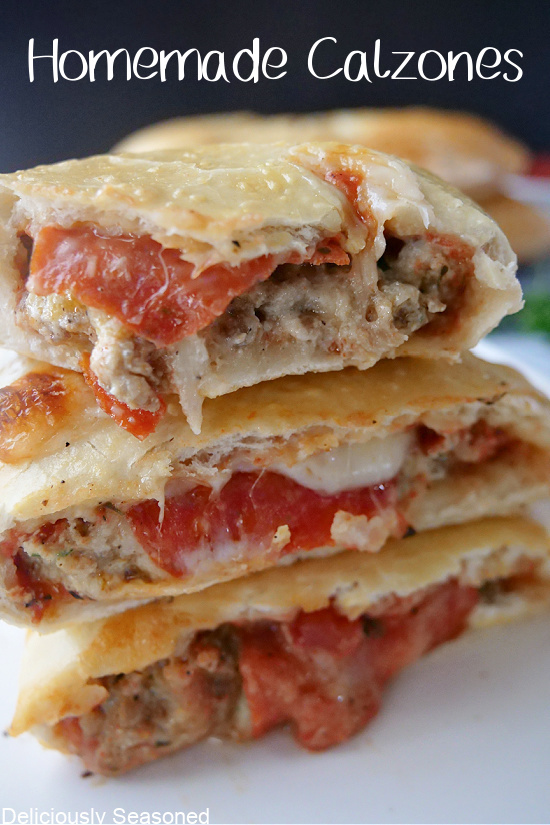 Homemade calzone recipe cut in half and stacked on top of each other showing the inside ingredients.