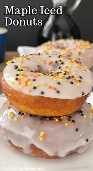 A close up of two donuts stacked on top of each other.