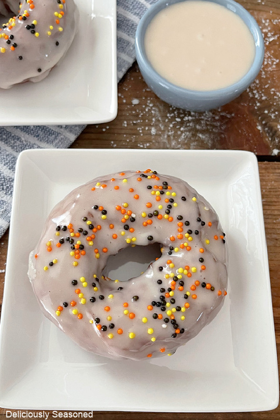 A close up of a homemade doughnut with icing and sprinkles.