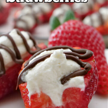 A white plate with strawberries on them, topped with whipped cream and drizzled with chocolate.