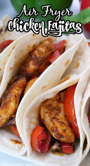 A close-up picture of air fryer chicken fajitas in soft flour tortillas on a white plate with the title at the top.