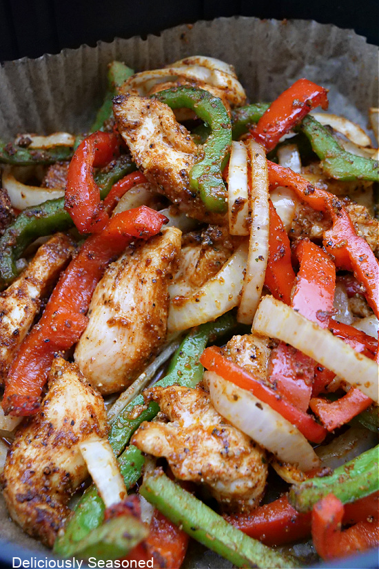 A close-up picture of chicken fajitas in the air fryer.