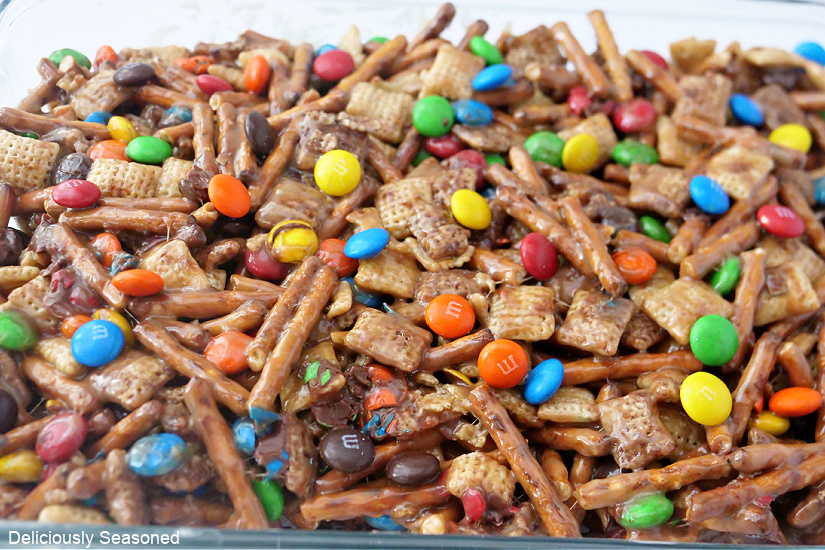 A horizontal picture of Chex Mix Bars with Pretzels and M&Ms in a glass baking dish.