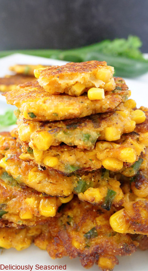 Corn fritters stacked up in a pile.