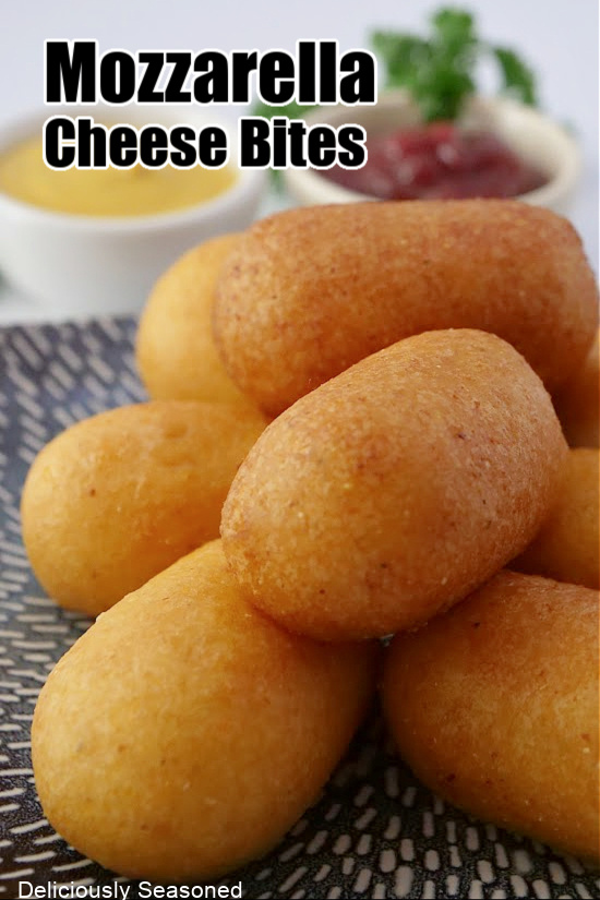 Cheese bites stacked on a blue plate with the title at the top of the pic.