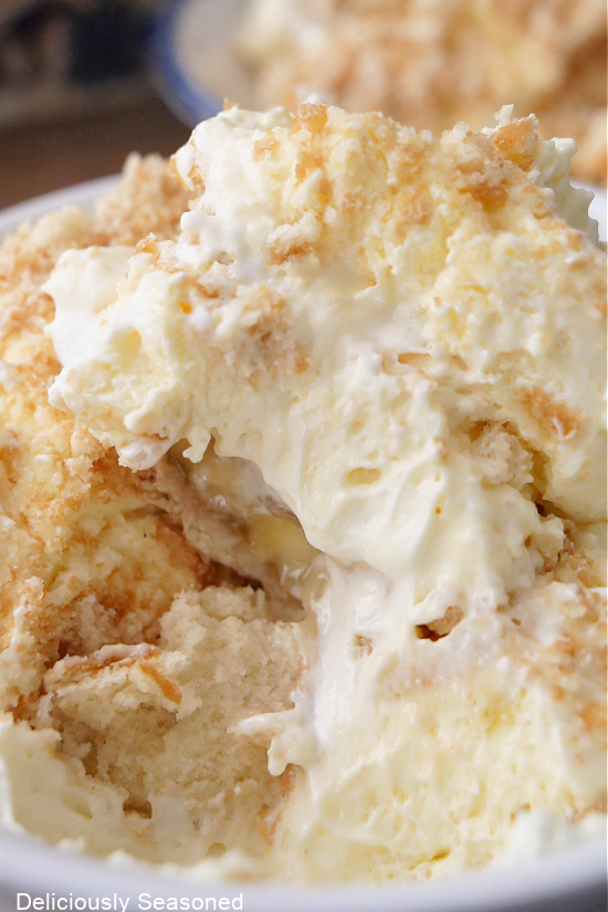Banana pudding layered with whipped cream and crushed vanilla wafers.