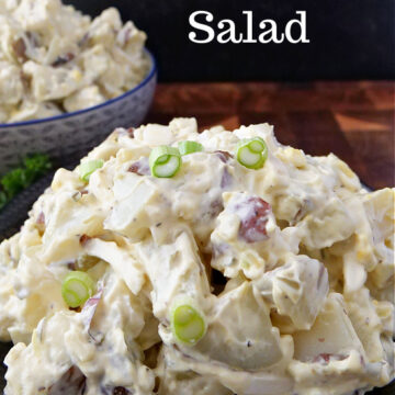 Red skinned potato salad in a bowl with sliced green onions on top and the title at the top.