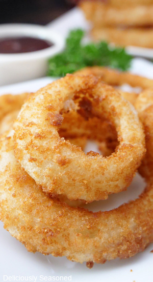 A close up picture of Alexia onion rings air fryer stacked on top of each other.