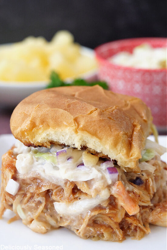 A close up of a Hawaiian BBQ Chicken slider on a white plate.