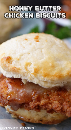 A close up picture of a chicken biscuit covered in honey butter.