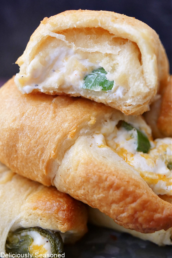 A close up picture showing a bite taken out of cream cheese filled crescent roll.