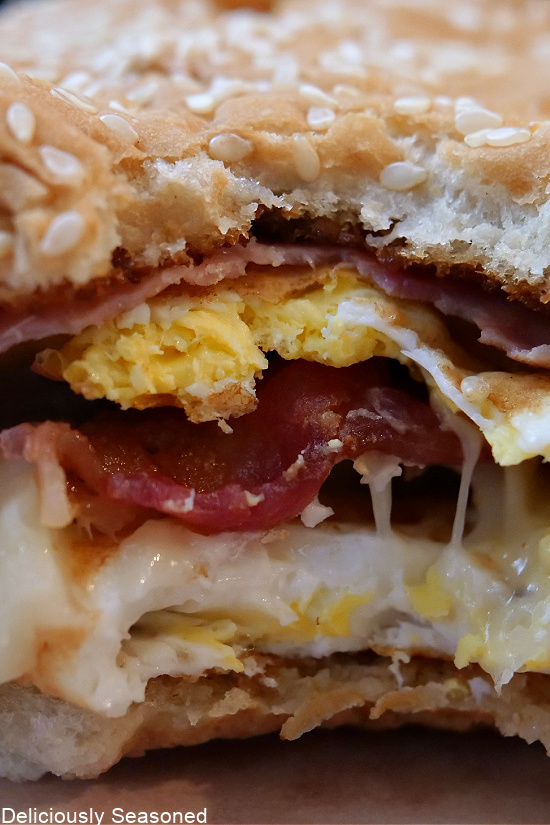 A close up photo of a bite taken out of a breakfast sandwich.
