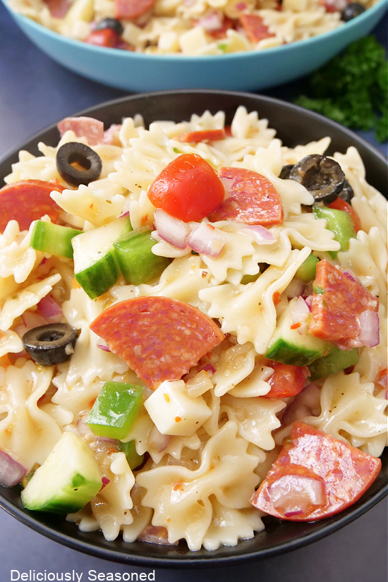 A black bowl filled with pasta salad.