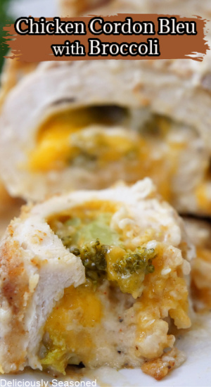 A slice of chicken on a white plate showing the cheese and broccoli that is stuffed inside.