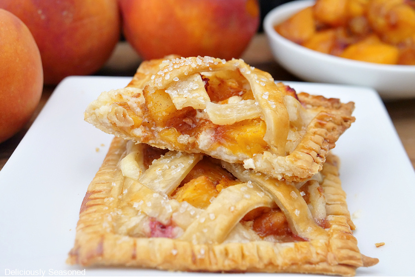 Two peach pastries on a white plate.
